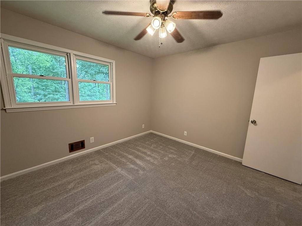 3155 Oak Drive Lawrenceville, GA 30044 - Photo 36 of 46 an empty room with a window and a fan