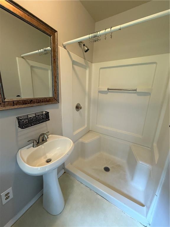 3155 Oak Drive Lawrenceville, GA 30044 - Photo 42 of 46 a bathroom with a sink mirror and shower