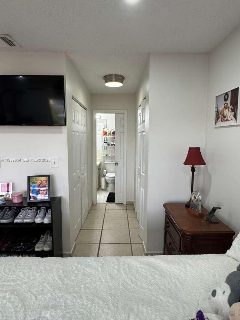 5083 West 12th Lane, Unit D6 Hialeah, FL 33012 - Photo 11 of 16 a living room with furniture and a flat screen tv