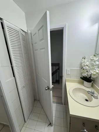 a bathroom with a sink a toilet a shower a vanity and a mirror