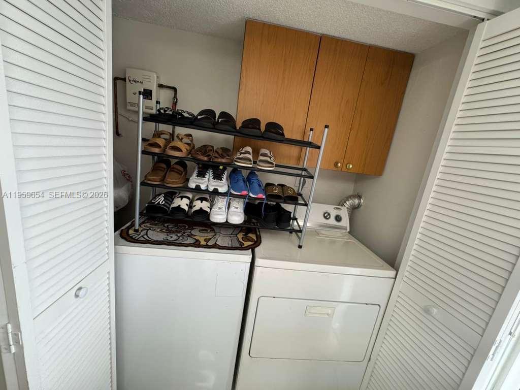5083 West 12th Lane, Unit D6 Hialeah, FL 33012 - Photo 16 of 16 a utility room with dryer and washer