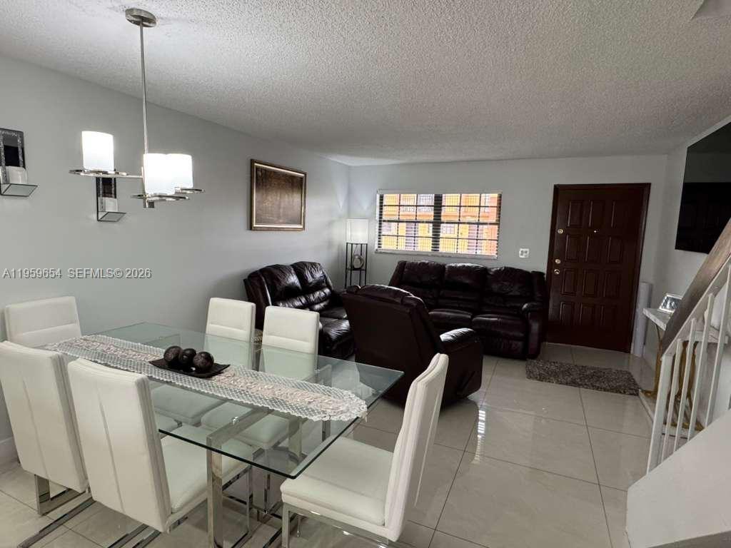 5083 West 12th Lane, Unit D6 Hialeah, FL 33012 - Photo 3 of 16 a view of a livingroom with furniture and window