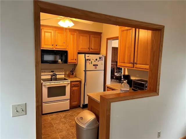 a kitchen with stainless steel appliances a stove a refrigerator sink and cabinets