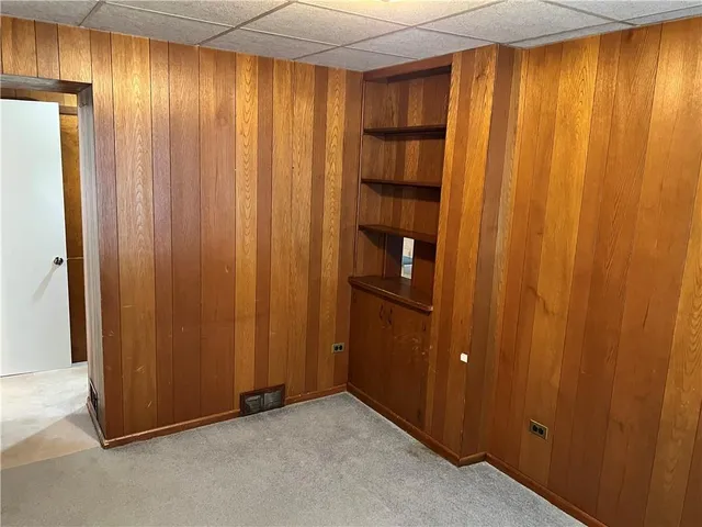 a view of an empty room with wooden walls