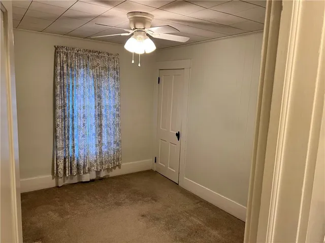 a view of a room with wooden floor and windows