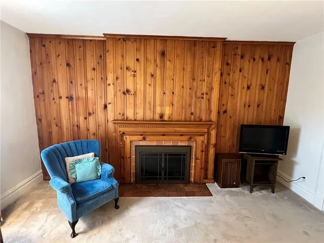 a living room with furniture a piano and a fireplace