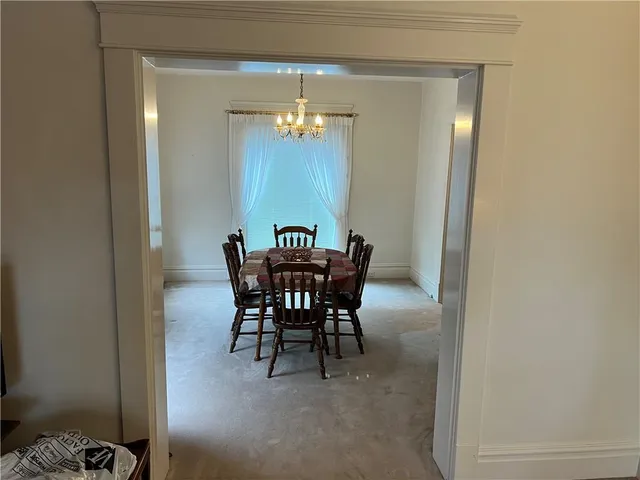 a view of a dining room with furniture and chandelier
