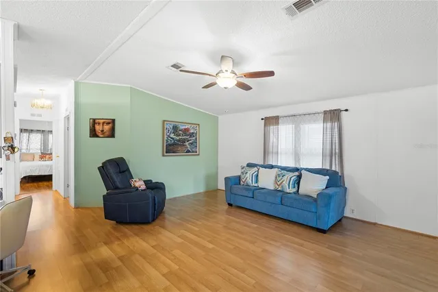 a living room with couches and a flat screen tv