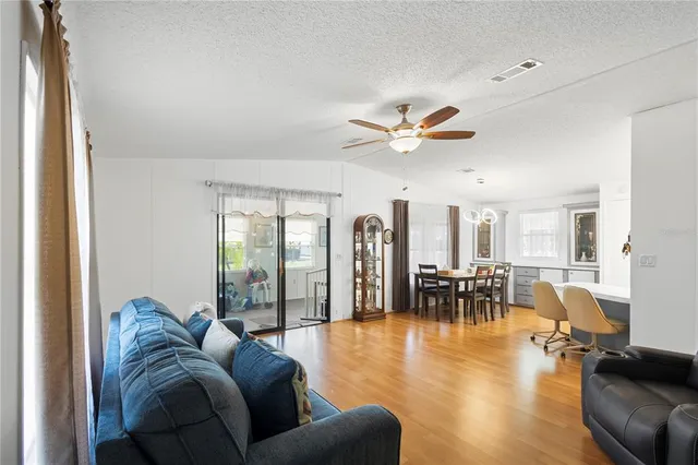a living room with furniture dining table and a large window