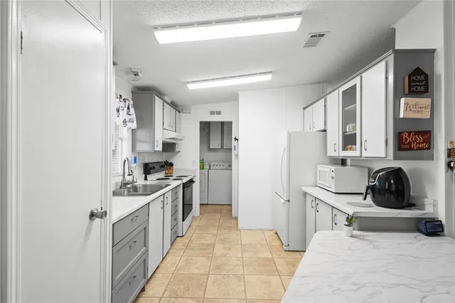 a kitchen with stainless steel appliances a sink stove and refrigerator