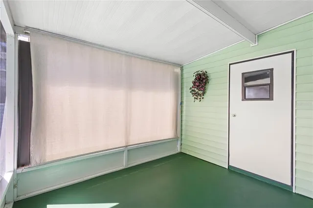 a view of an empty room with window and stairs
