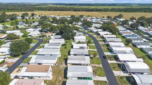 an aerial view of a city with lots of residential buildings lake and ocean view