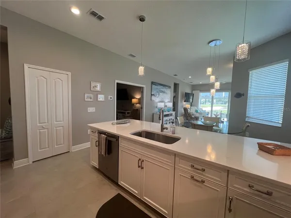 a kitchen with sink stove and cabinets