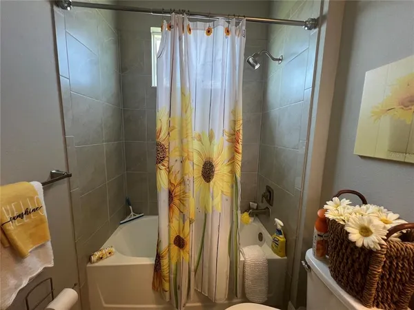 a bathroom with a tub and shower