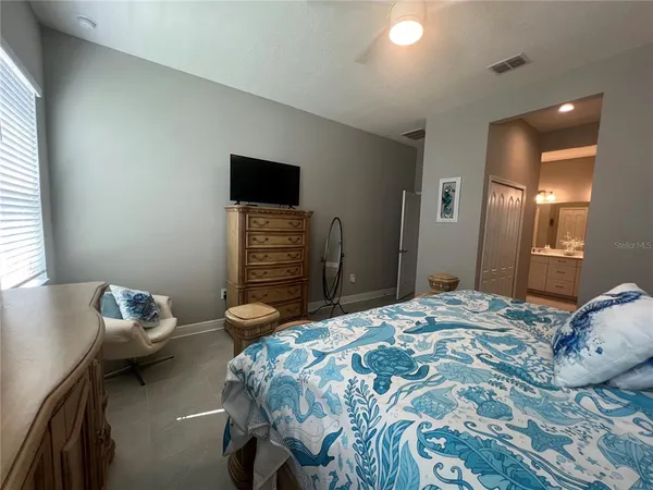 a bedroom with a bed and a television