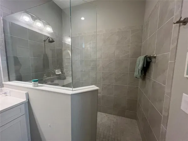 a bathroom with a shower and sink