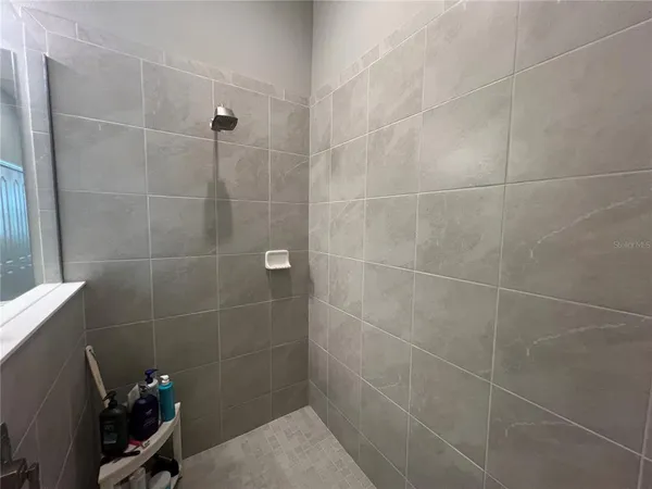 a bathroom with a double vanity sink and mirror