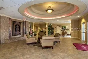 a living room with furniture and a view of kitchen
