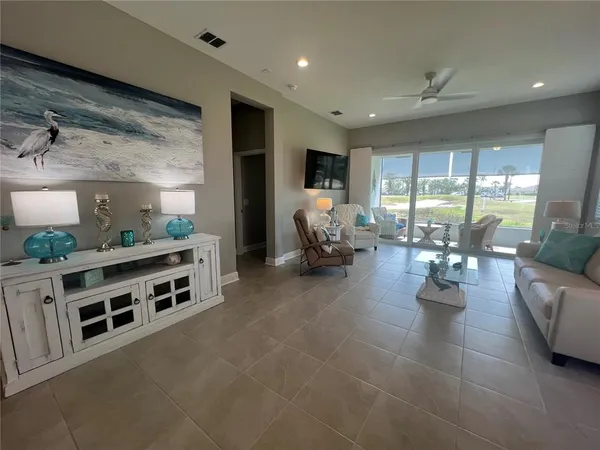 a living room with furniture and large windows