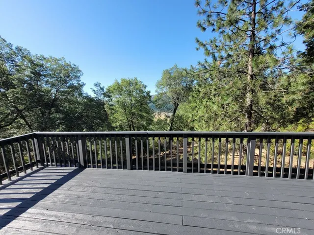 a view of balcony with wooden floor and fence