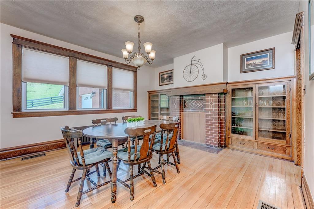 474 Scott Run Road Sycamore, PA 15364 - Photo 12 of 25 a view of a dining room with furniture window and wooden floor