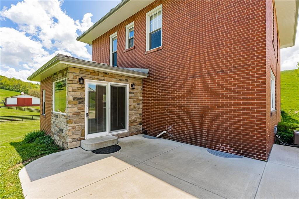 474 Scott Run Road Sycamore, PA 15364 - Photo 6 of 25 a front view of a house with a garden