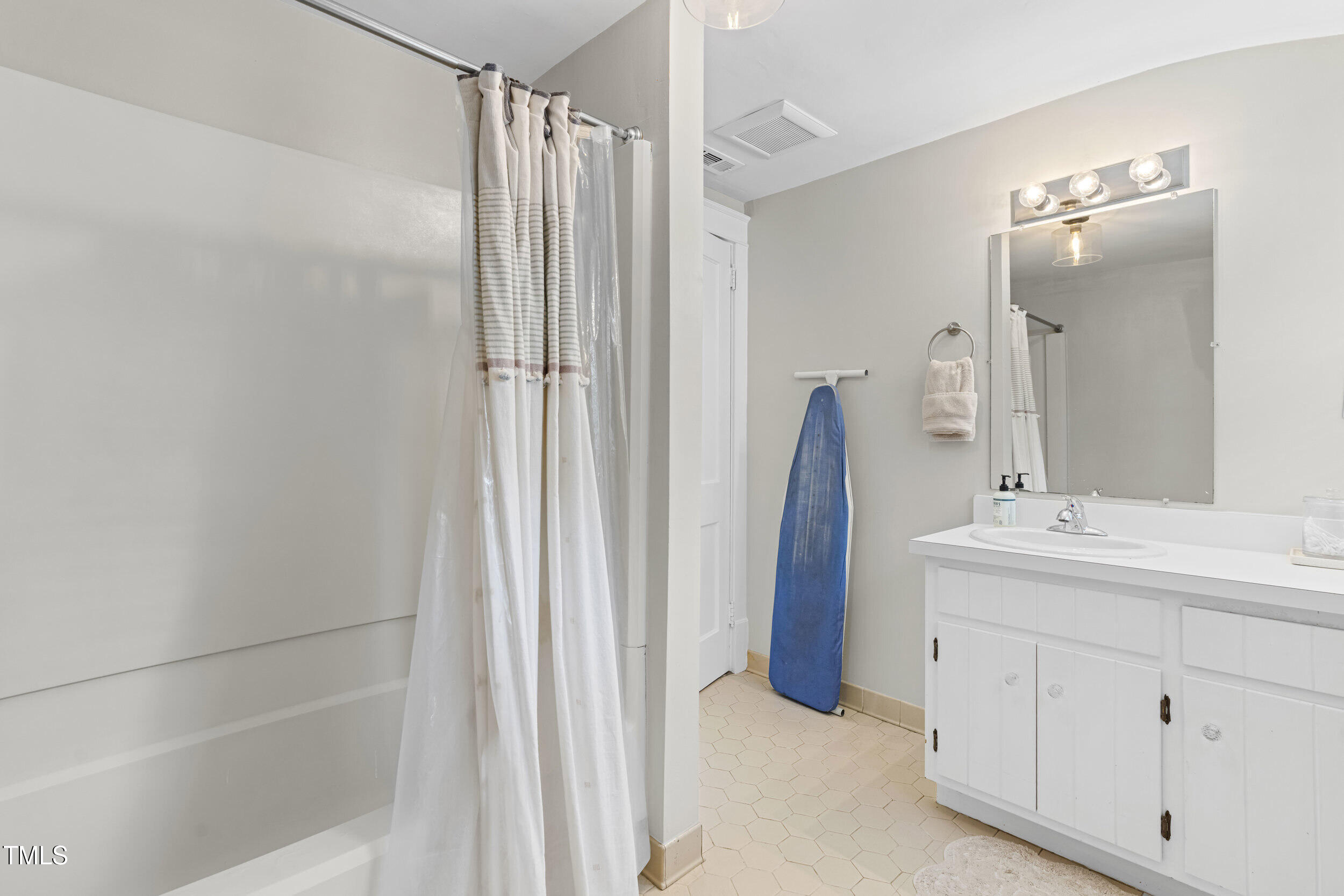 1314 Wake Forest Road Raleigh, NC 27604 - Photo 26 of 32 a bathroom with a double vanity sink and mirror