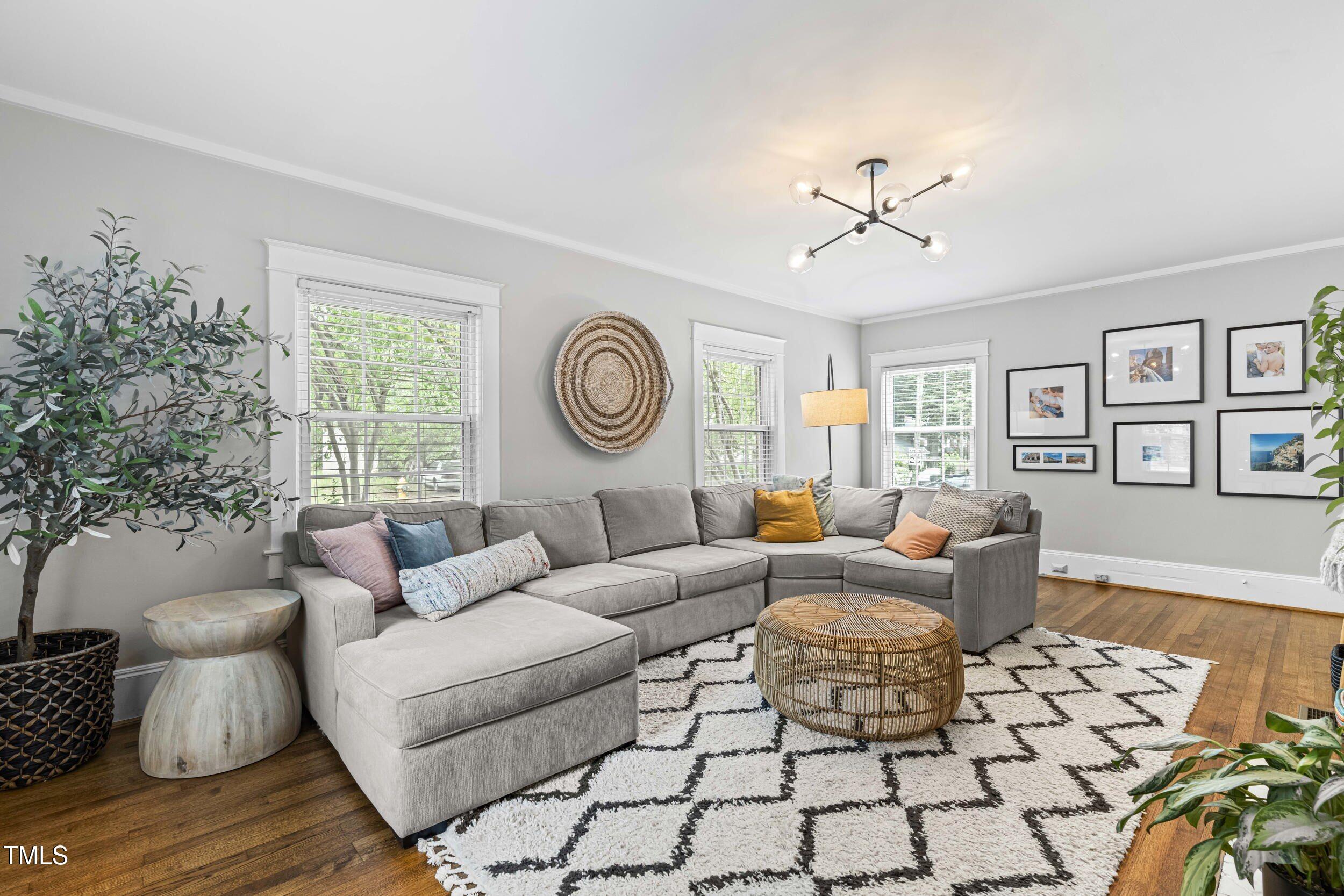 1314 Wake Forest Road Raleigh, NC 27604 - Photo 4 of 32 a living room with furniture a clock and a window