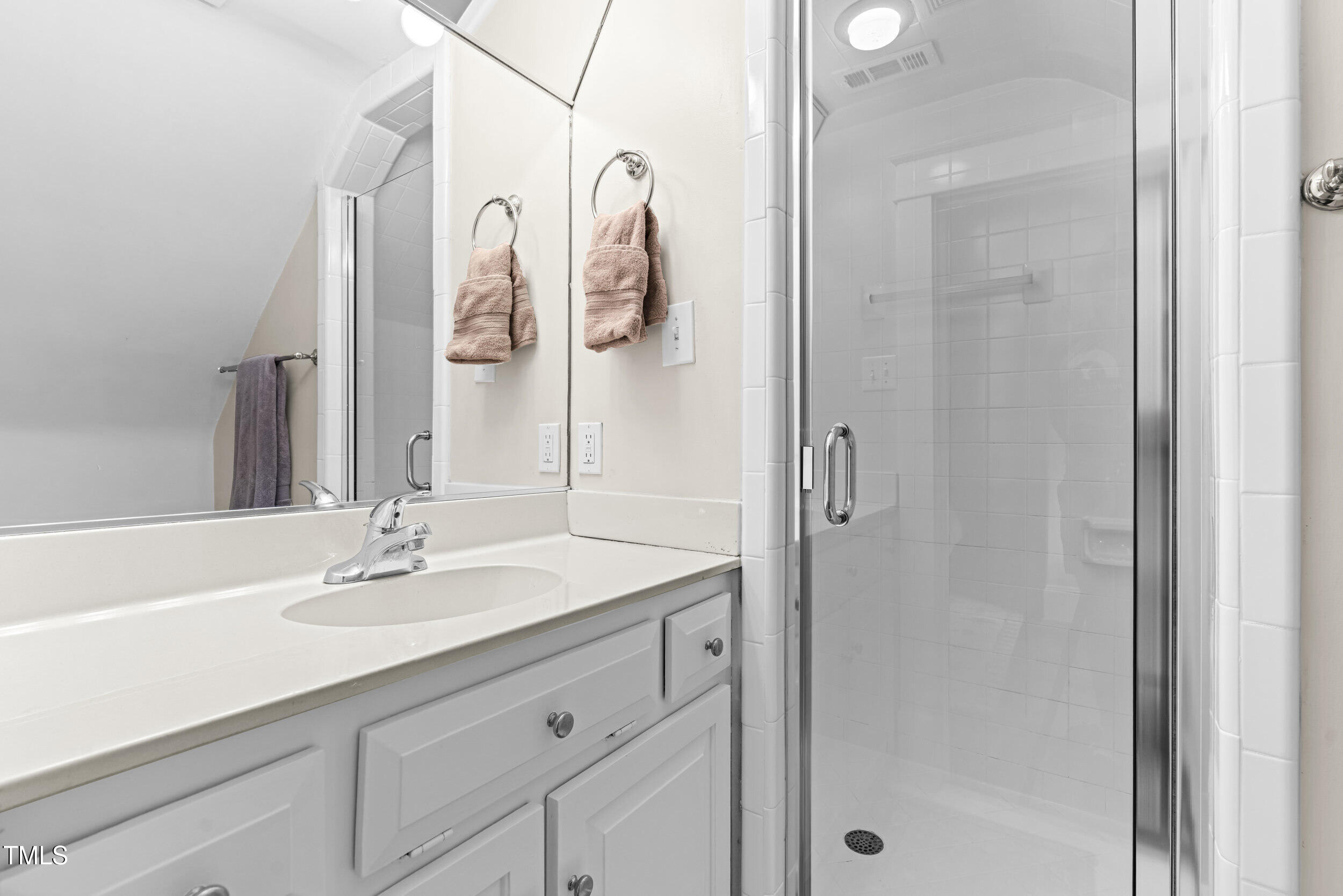 1314 Wake Forest Road Raleigh, NC 27604 - Photo 8 of 32 a bathroom with a shower sink vanity and mirror