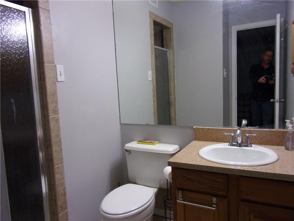 18240 Midway Road, Unit 105 Dallas, TX 75287 - Photo 20 of 37 a bathroom with a sink a toilet and mirror