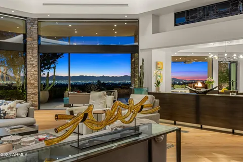 a living room with furniture and a floor to ceiling window