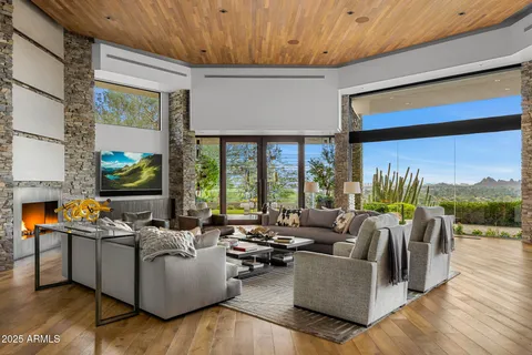 a living room with furniture and a floor to ceiling window