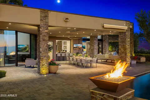 a view of a back yard of the house and cars parked