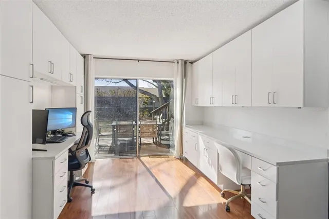 a kitchen with granite countertop a stove a sink and a refrigerator