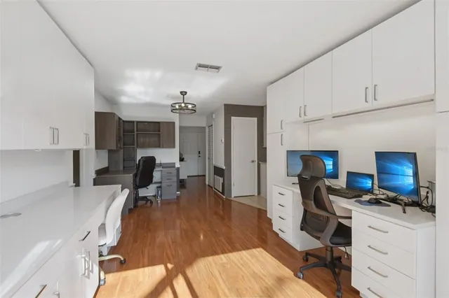 a view of a kitchen with workspace and living room