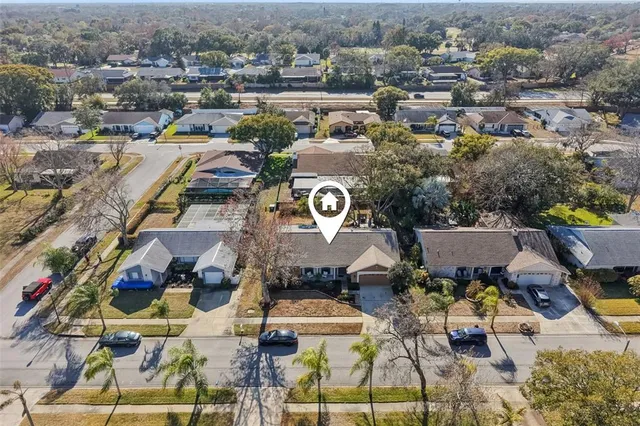 an aerial view of a houses with yard