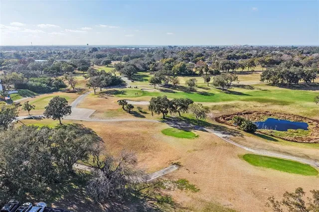 an aerial view of a house with a yard and lake view