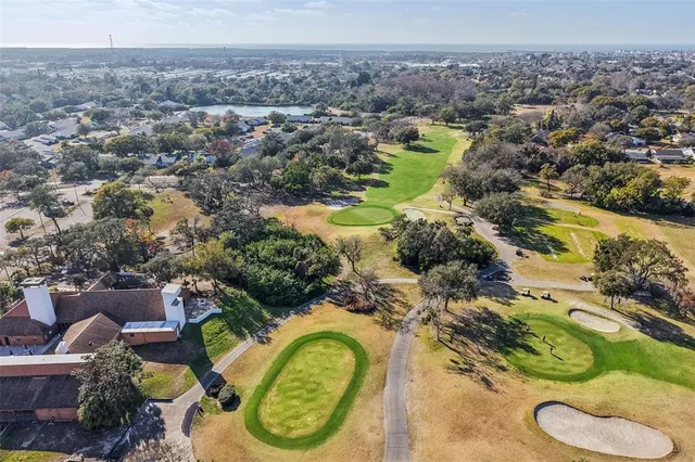 an aerial view of a house with yard swimming pool and outdoor seating