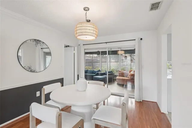 a view of a dining room with furniture wooden floor and chandelier