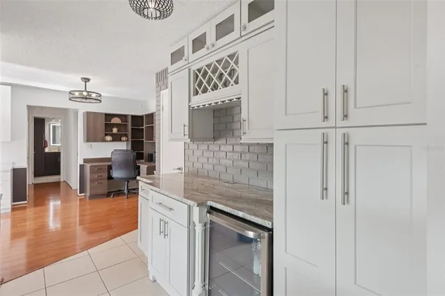 a kitchen with stainless steel appliances granite countertop a refrigerator and cabinets
