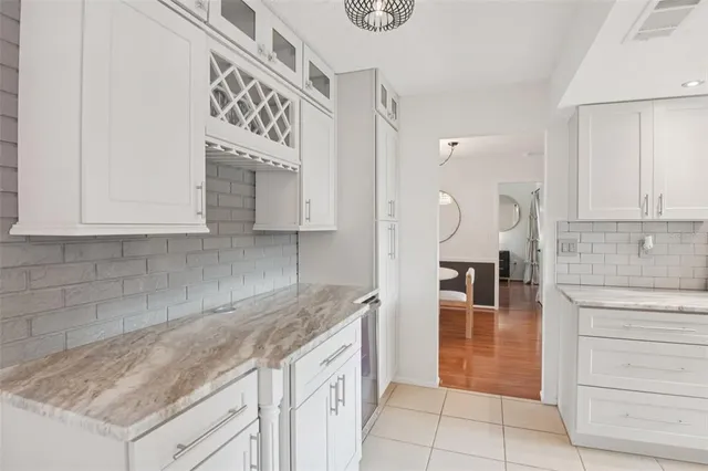 a kitchen with granite countertop a sink a stove and cabinets
