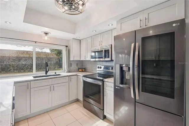 a kitchen with a sink stainless steel appliances and cabinets