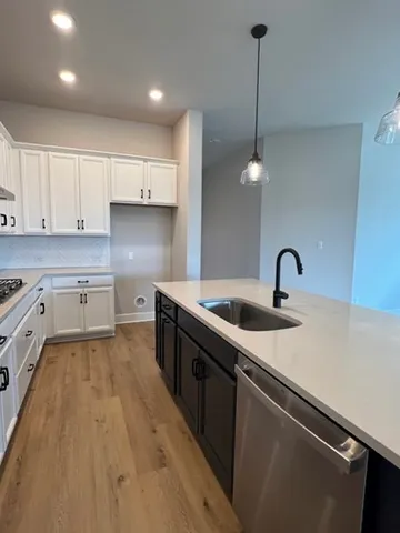 a kitchen with a sink appliances and cabinets