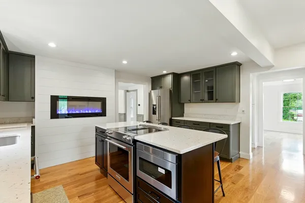 a kitchen with stainless steel appliances granite countertop a stove and a refrigerator