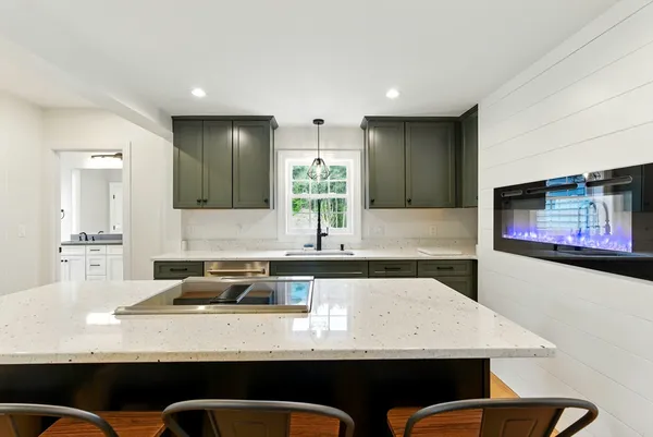 a kitchen with stainless steel appliances granite countertop a sink a counter space and cabinets