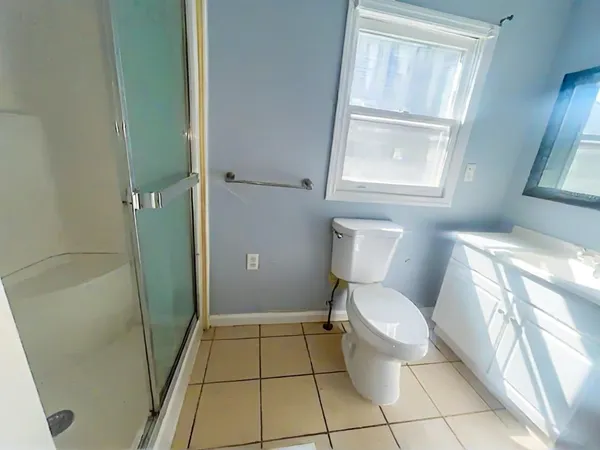 a bathroom with a toilet and a shower