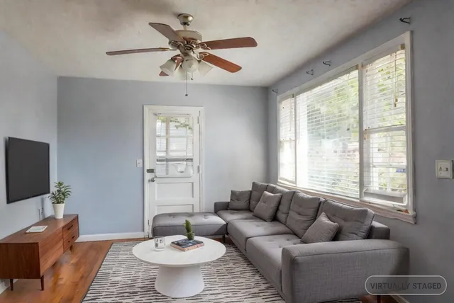 a living room with furniture and a large window