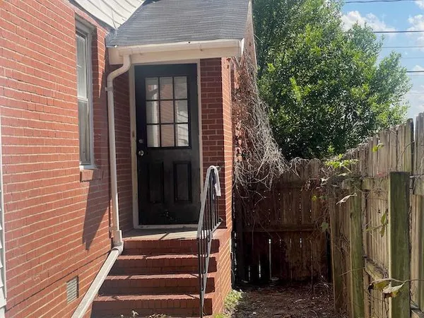 a view of a house with a door and wooden floor