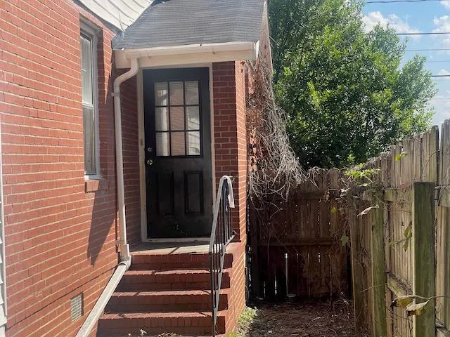 a view of a house with a door and wooden floor