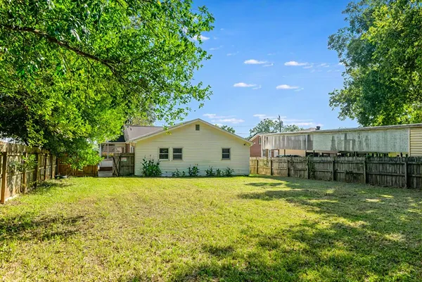 a view of a house with backyard and sitting area